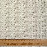 Popeline de coton imprimée esquisse florale marron fond écru