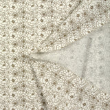 Popeline de coton imprimée esquisse florale marron fond écru