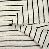 Jersey de coton flammé pointelle rayé noir et blanc cassé