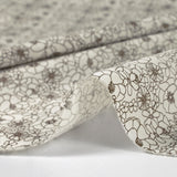 Popeline de coton imprimée esquisse florale marron fond écru