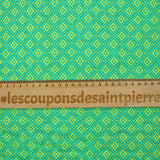 Coton matelassé double face ethnique et fleurs vert anis au mètre