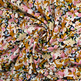 Viscosa estampada con flores de Ornella mostaza, rosa y celeste.