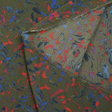 Crinkle muslin printed in royal blue and red with khaki background