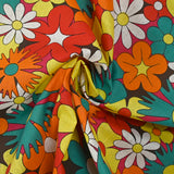 Algodón con estampado de flores disco en rojo, naranja y turquesa