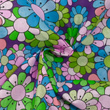 Coton imprimé flower power parme fond violet