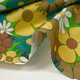 Coton imprimé floraison disco turquoise, marron et jaune beurre