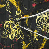 Printed muslin, satin band, chains and tassels, black background