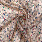 Mousseline imprimée bande satin fleurs vagabondes fond rose poudré