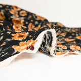 Dentelle imprimée fleurs camel fond noir