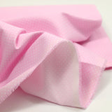 Cotton stung printed with polka dot pink background