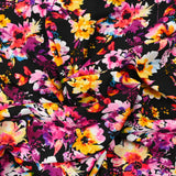 Viscose imprimée danse de fleurs rose et orange fond noir