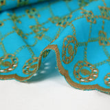 Beige scalloped English embroidery Clémence azure blue background