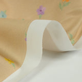 Printed cotton small colorful flowers beige background