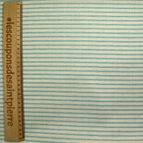 Cotton printed with turquoise churrant stripes light beige background