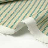 Cotton printed with turquoise churrant stripes light beige background