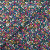 Mousseline de polyester lancée découpée fleurs fond turquoise