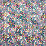 Mousseline de polyester lancée découpée fleurs fond turquoise