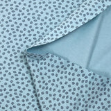Punto de algodón estampado hojas fondo azul cielo