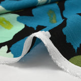 Crépon de viscose imprimé éclat de fleurs pétrole et anis fond noir