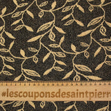 Maille dentelle ajourée motif végétal doré fond noir