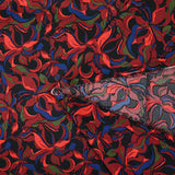 Crêpe satiné de polyester Amaryllis bordeaux et bleu marine fond noir