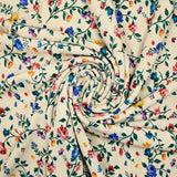 Viscose knit printed with small country flowers on beige background