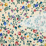 Viscose knit printed with small country flowers on beige background