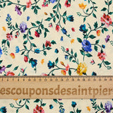 Viscose knit printed with small country flowers on beige background