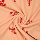 Double gauze printed with red lobster and apricot background