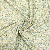 Voile de coton imprimé digital fleurettes jaunes et feuillage vert sur fond crème