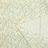 Voile de coton imprimé digital fleurettes jaunes et feuillage vert sur fond crème