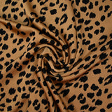 Crêpe satiné de polyester sauvage noire fond mordoré