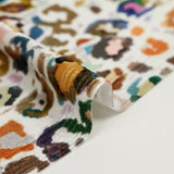 Short-sleeved velvet jersey with multicolored leopard print and white background