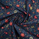 Popelina de algodón estampada con flores de pascua y lazos rojos sobre fondo azul marino
