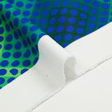 Gabardine de polyester imprimée petit pois bleu fond vert