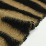 Wool woolen wool and black tiger silk brown background