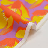 Satin de coton élasthanne fleurs orange fond violet