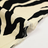 Viscose twill with black zebra print, ivory background