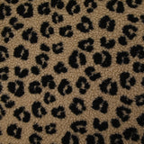 Fausse fourrure sherpa léopard noir fond marron