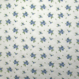 Jersey de coton matelassé imprimé fleurettes bleu fond blanc