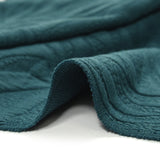 Jersey matelassé fissures fond pétrole