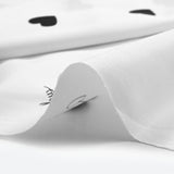 Cotton poplin printed black heart white background