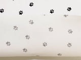 Tissus Piqué de coton imprimé pattes de chien noires sur fond blanc