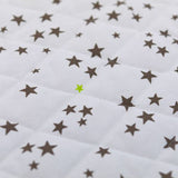 Estrellas de topo mate mate de algodón y verde anís por metro