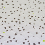 Estrellas de topo mate mate de algodón y verde anís por metro