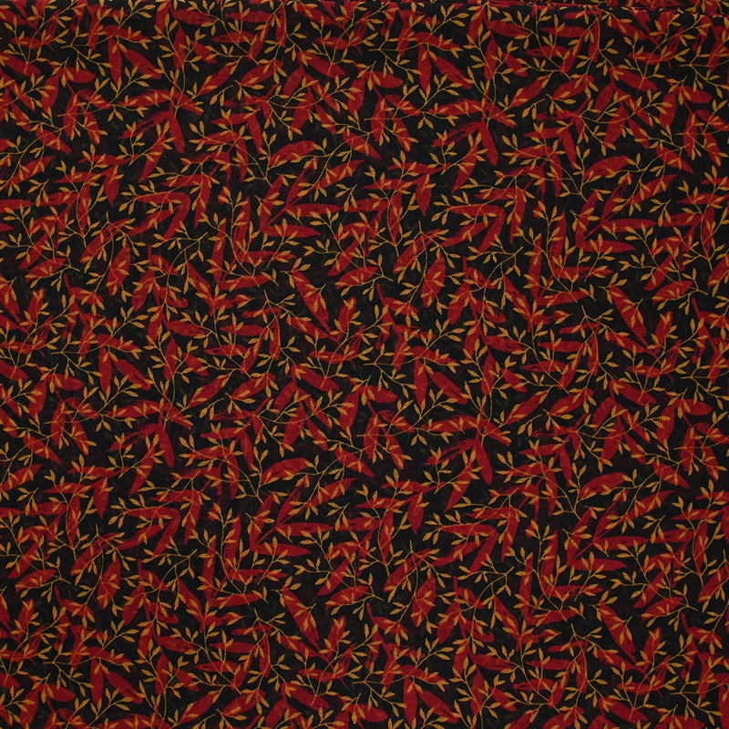 Mousseline imprimée feuilles rouge et ocre fond noir
