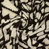 Maille de polyester imprimée ikat marron fond écru