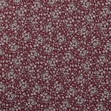 Crêpe viscose imprimé petites fleurs blanches fond bordeaux foncé