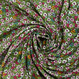 Printed viscose multicolored flowers green background