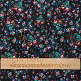 Crêpe viscose imprimé fleurs éclatantes vertes et orange fond noir